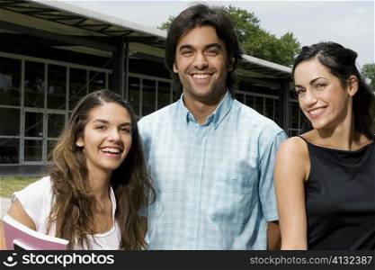 Portrait of three university students smiling