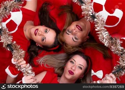 Portrait of three women from above with a christmas garland frame