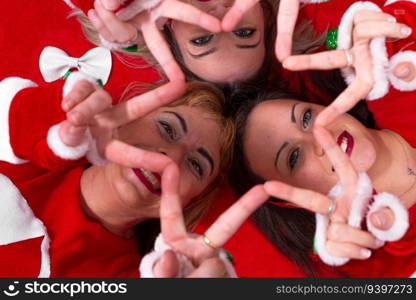 Portrait of three women making a star with fingers from above