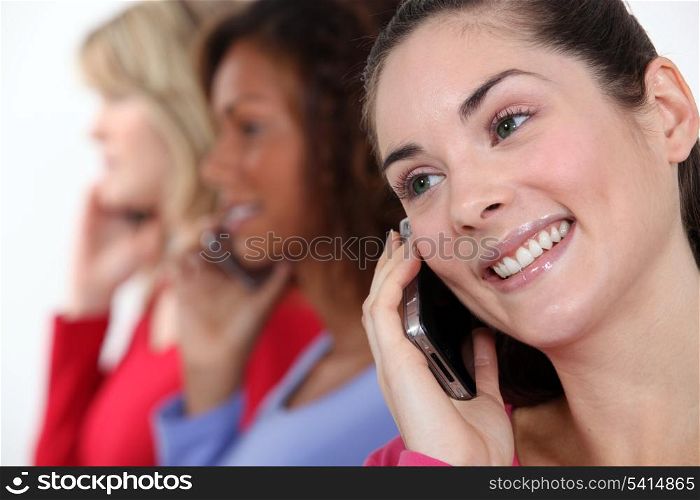 Portrait of three women on the phone