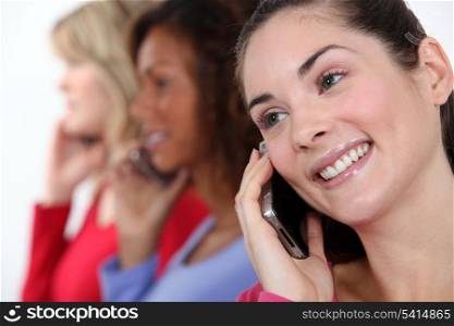 Portrait of three women on the phone