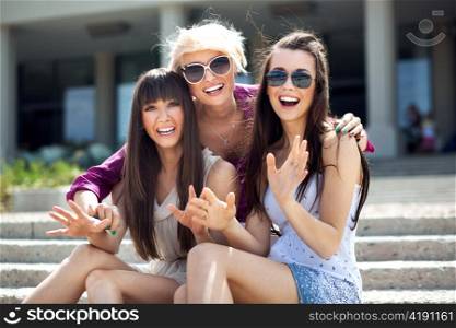 Portrait of three young ladies wearing sunglasses