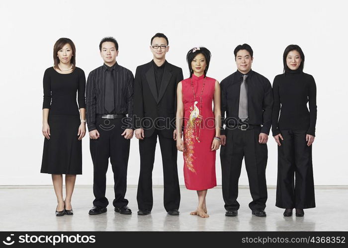 Portrait of three young men and three young women looking serious