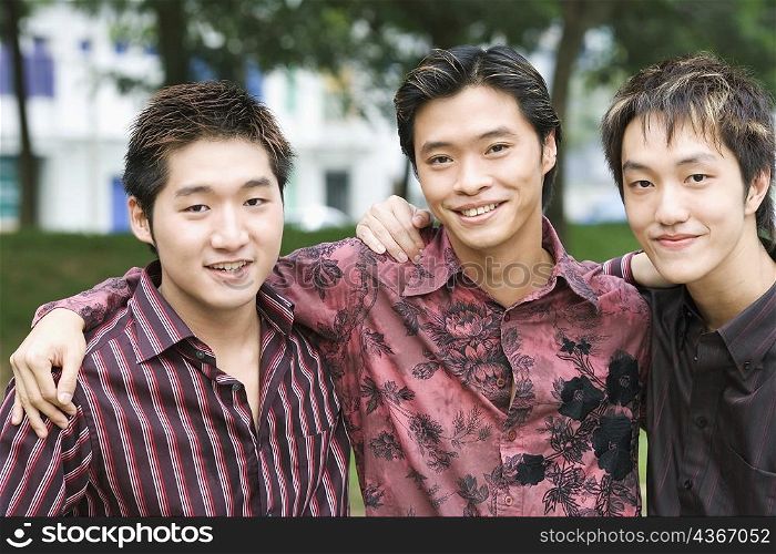 Portrait of three young men smiling