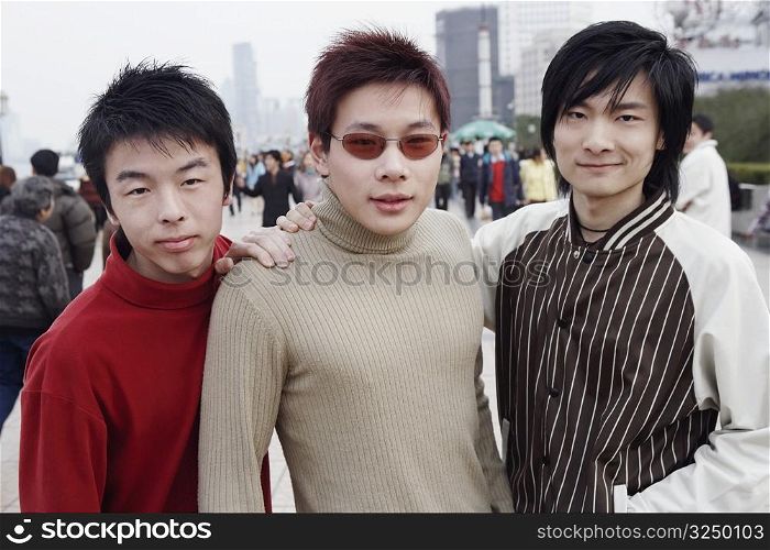 Portrait of three young men standing in the market