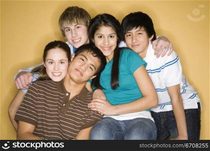 Portrait of three young men with two young women smiling