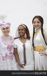 Portrait of three young multi-ethnic women in their traditional clothing, studio shot