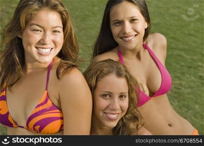 Portrait of three young women in a lawn