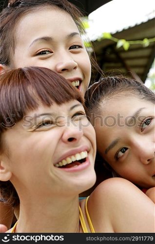 Portrait of three young women laughing