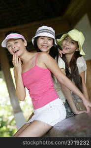 Portrait of three young women laughing