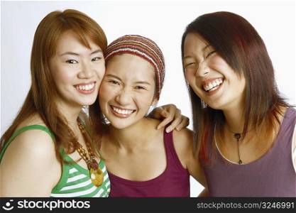 Portrait of three young women posing and smiling