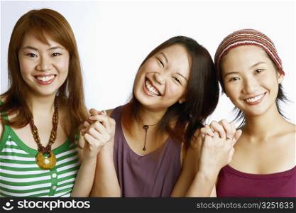 Portrait of three young women posing and smiling
