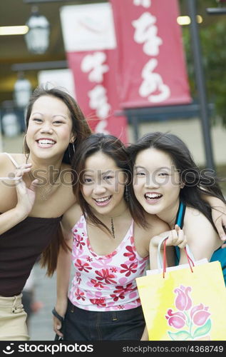 Portrait of three young women smiling