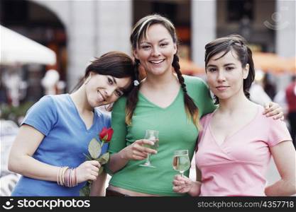 Portrait of three young women standing together