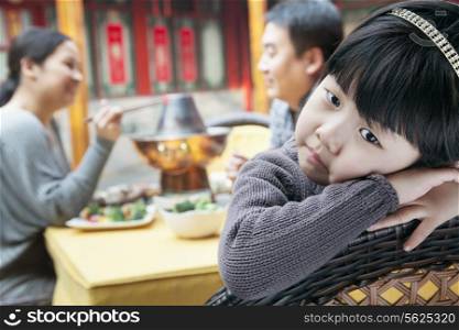 Portrait of tired little girl at family meal