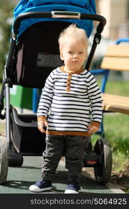 Portrait of toddler child outdoors. One year old baby boy at playground