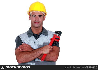 portrait of tradesman cross-armed holding adjustable spanner