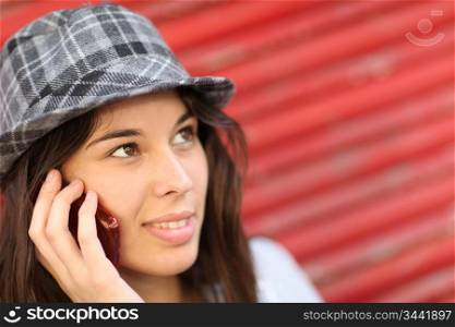 Portrait of trendy girl leaning on red background