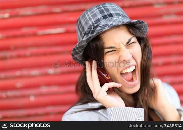 Portrait of trendy girl shouting on the phone