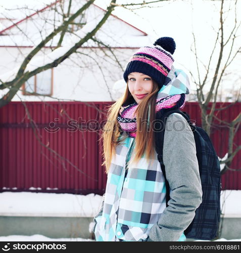 Portrait of Trendy Hipster Girl on Bright Winter Clothes, Traveler Woman with Backpacks. Freedom and Active Lifestyle Concept Photography Toned Style Instagram Filters.