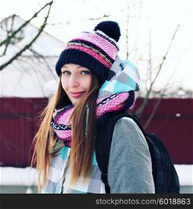 Portrait of Trendy Hipster Girl on Bright Winter Clothes, Traveler Woman with Backpacks. Freedom and Active Lifestyle Concept Photography Toned Style Instagram Filters.