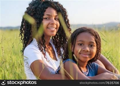 Portrait of two african sisters in the nature and loonking at the camera