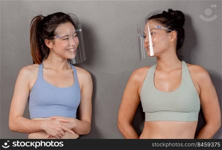 Portrait of two Asian women beautiful woman wearing mask or face shield to protect virus in gym