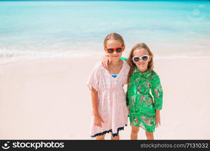 Portrait of two beautiful kids on the beach. Kids have a lot of fun at tropical beach playing together