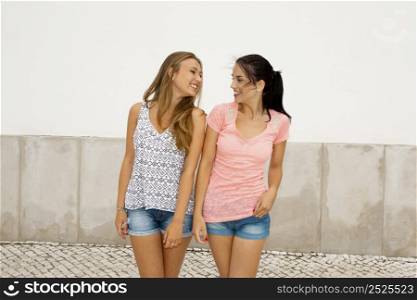 Portrait of two beautiful young girls smiling