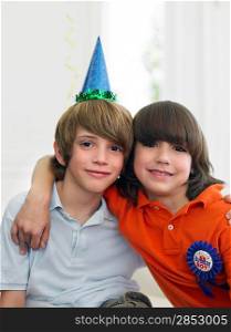 Portrait of two boys (10-12) at birthday party