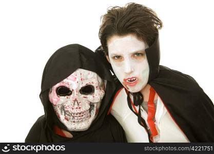 Portrait of two boys dressed in scary Halloween costumes. Isolated on white.