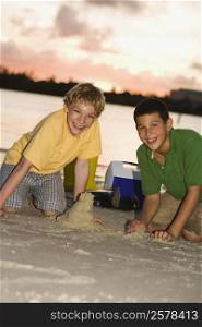Portrait of two boys making sand castles