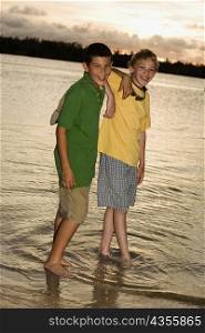 Portrait of two boys standing on the beach