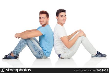 Portrait of two brothers sitting back to back isolated on a white background