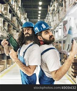 Portrait of two builders in a warehouse