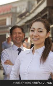 Portrait of two Business People, focus on businesswomen, outdoors, Beijing