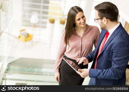 Portrait of two business people on the stairs in the office