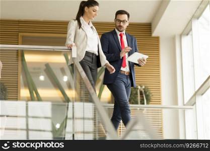 Portrait of two business people on the stairs in the office