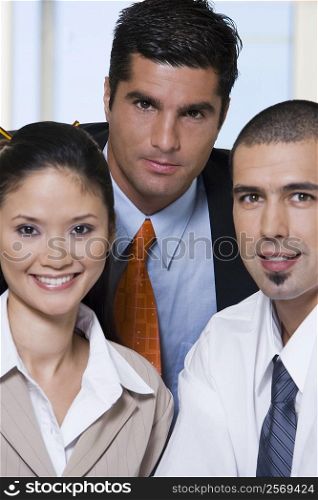 Portrait of two businessmen and a businesswoman in an office
