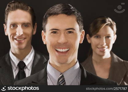 Portrait of two businessmen and a businesswoman smiling