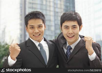 Portrait of Two Businessmen Cheering