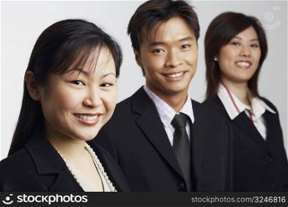 Portrait of two businesswomen and a businessman smiling