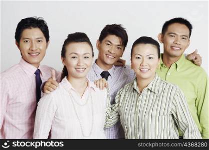 Portrait of two businesswomen and three businessmen smiling