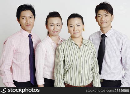 Portrait of two businesswomen and two businessmen smiling