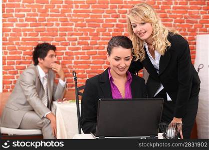 portrait of two businesswomen at restaurant