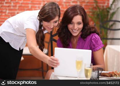 portrait of two businesswomen at restaurant