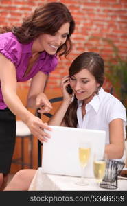 portrait of two businesswomen at restaurant