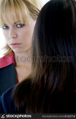 Portrait of two businesswomen standing face to face