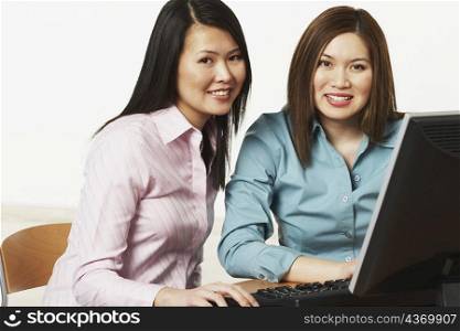 Portrait of two businesswomen using a computer