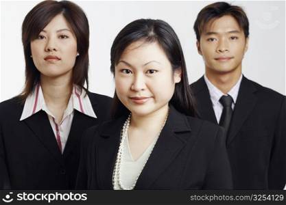 Portrait of two businesswomen with a businessman